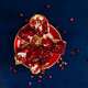 ripe pomegranate broken into pieces on blue wooden background ripe pomegranate broken into pieces on blue wooden background - PhotoDune Item for Sale