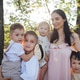 Woman holding children in a sunlit outdoor setting, surrounded by trees Woman holding children in a sunlit outdoor setting, surrounded by trees - PhotoDune Item for Sale