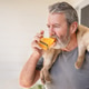Mature handsome bearded man drinking orange juice or vitamin drink Mature handsome bearded man drinking orange juice or vitamin drink - PhotoDune Item for Sale