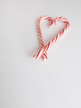All we need is Love! Merry Christmas candy cane heart on white background with copy space. All we need is Love! Merry Christmas candy cane heart on white background with copy space. - PhotoDune Item for Sale
