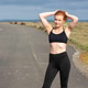 Woman wearing exercise clothes outside on country road Woman wearing exercise clothes outside on country road - PhotoDune Item for Sale