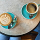 Two cups of coffee latte and americano on a marble table. Two cups of coffee latte and americano on a marble table. - PhotoDune Item for Sale
