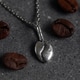 Elegant Silver Coffee Bean Pendant Necklace on Gray Background. Stylish Jewelry for Coffee Lovers. Elegant Silver Coffee Bean Pendant Necklace on Gray Background. Stylish Jewelry for Coffee Lovers. - PhotoDune Item for Sale