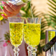 Sparkling lemon yellow limoncello poured into high crystal glasses by young woman beautiful hands Sparkling lemon yellow limoncello poured into high crystal glasses by young woman beautiful hands - PhotoDune Item for Sale