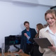 Professional woman is focused on her tablet while two colleagues engage in conversation in office Professional woman is focused on her tablet while two colleagues engage in conversation in office - PhotoDune Item for Sale