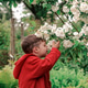 Boy smell sweet white flower in the garden Boy smell sweet white flower in the garden - PhotoDune Item for Sale