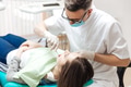 Professional dentist doing teeth checkup on female patient dental surgery Professional dentist doing teeth checkup on female patient dental surgery - PhotoDune Item for Sale