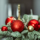 composition with a candle, red and gold ornaments. The concept of Christmas and New Year composition with a candle, red and gold ornaments. The concept of Christmas and New Year - PhotoDune Item for Sale