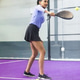 Indian female preparing to hit yellow ball with padel paddle on purple court wearing lavender top Indian female preparing to hit yellow ball with padel paddle on purple court wearing lavender top - PhotoDune Item for Sale