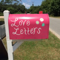 Cute pink mail box with the phrase “Love Letters at home’s front yard in the neighborhood Cute pink mail box with the phrase “Love Letters at home’s front yard in the neighborhood - PhotoDune Item for Sale