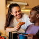 Lesbian couple sharing croissant during intimate home breakfast Lesbian couple sharing croissant during intimate home breakfast - PhotoDune Item for Sale