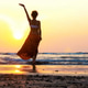 Silhouette of young girl dancing at sunset Silhouette of young girl dancing at sunset - PhotoDune Item for Sale