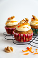 carrot cake muffins with icing and carrot shaving on cooling rack white background carrot cake muffins with icing and carrot shaving on cooling rack white background - PhotoDune Item for Sale