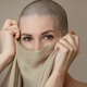 Young slender woman after chemotherapy without hair on her head covers her face and mouth with a Young slender woman after chemotherapy without hair on her head covers her face and mouth with a - PhotoDune Item for Sale