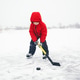Young Child Playing Hockey on a Snowy Frozen Lake Outdoors Young Child Playing Hockey on a Snowy Frozen Lake Outdoors - PhotoDune Item for Sale