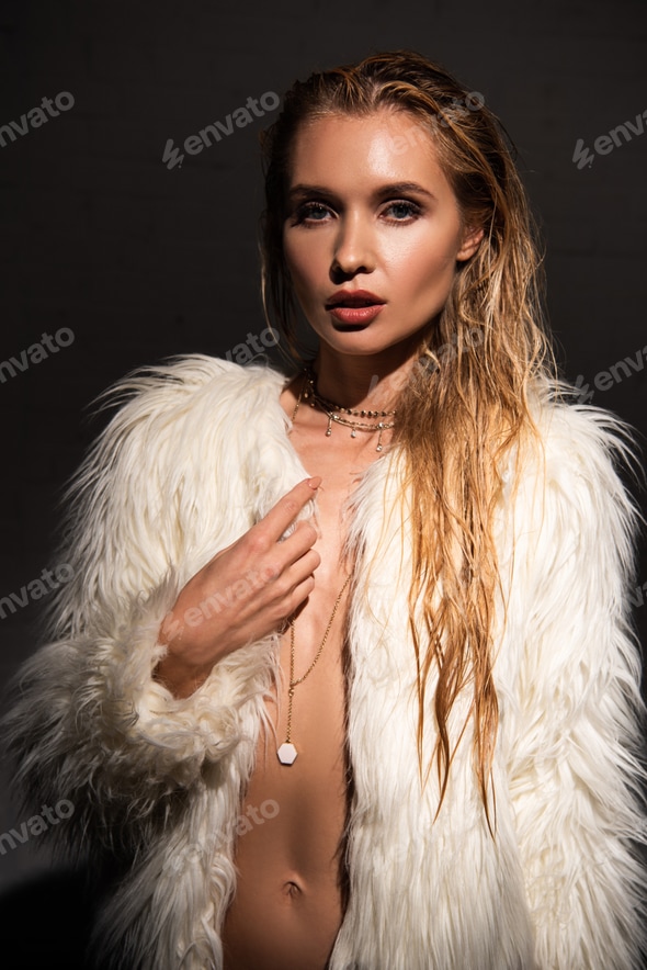 sexy young woman with blonde hair in white faux fur coat isolated on black Stock Photo by LightFieldStudios sexy young woman with blonde hair in white faux fur coat isolated on black Stock Photo by LightFieldStudios