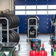 Racing tires stored racks inside motorsport garage service equipment fluids prepared competition. Racing tires stored racks inside motorsport garage service equipment fluids prepared competition. - PhotoDune Item for Sale