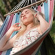 Caucasian girl 20 years old with headphones relaxing in a hammock, sunbathing and listening to music Caucasian girl 20 years old with headphones relaxing in a hammock, sunbathing and listening to music - PhotoDune Item for Sale