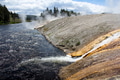 Yellowstone colorful landscape view of the stream of steaming water as it flows into the wavy river. Yellowstone colorful landscape view of the stream of steaming water as it flows into the wavy river. - PhotoDune Item for Sale