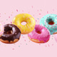 Assortment of falling brightly colored donuts with falling sprinkles Assortment of falling brightly colored donuts with falling sprinkles - PhotoDune Item for Sale