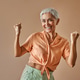Portrait of a modern woman wearing an orange t-shirt and green pants of pastel shades who is emotion Portrait of a modern woman wearing an orange t-shirt and green pants of pastel shades who is emotion - PhotoDune Item for Sale