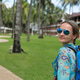 beautiful girl with blue backpack on a path with palm trees beautiful girl with blue backpack on a path with palm trees - PhotoDune Item for Sale