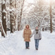 Walking mother with teen son on snowy forest road, tall trees, calm winter landscape, family time Walking mother with teen son on snowy forest road, tall trees, calm winter landscape, family time - PhotoDune Item for Sale