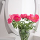 Vertical view of an elegant dressing table with a mirror and pink peonies. Vertical view of an elegant dressing table with a mirror and pink peonies. - PhotoDune Item for Sale