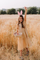 Teen girl in wheat field with easter bunny ears collecting painted eggs in basket Teen girl in wheat field with easter bunny ears collecting painted eggs in basket - PhotoDune Item for Sale