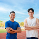 Two asian athlete men are standing with arms crossed, Posing and looking at camera on the racetrack. Two asian athlete men are standing with arms crossed, Posing and looking at camera on the racetrack. - PhotoDune Item for Sale
