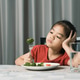 Little cute kid girl refusing to eat healthy vegetables. Children do not like to eat vegetables. Little cute kid girl refusing to eat healthy vegetables. Children do not like to eat vegetables. - PhotoDune Item for Sale