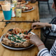 Woman enjoying her neapolitan pizza. Woman enjoying her neapolitan pizza. - PhotoDune Item for Sale