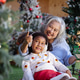 A loving grandmother and her granddaughter share a joyful moment during Christmas A loving grandmother and her granddaughter share a joyful moment during Christmas - PhotoDune Item for Sale
