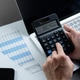 Businessman hands using a calculator to check company finances and earnings and budget. Businessman hands using a calculator to check company finances and earnings and budget. - PhotoDune Item for Sale