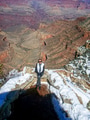 Latino Hispanic woman seating on top of Grand Canyon desert with snow & Canyon view in background Latino Hispanic woman seating on top of Grand Canyon desert with snow & Canyon view in background - PhotoDune Item for Sale