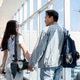 Back view of asian man and woman tourist couple go on a trip holding hands and walking in airport. Back view of asian man and woman tourist couple go on a trip holding hands and walking in airport. - PhotoDune Item for Sale
