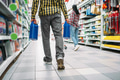 Man with engine oil, couple in supermarket Man with engine oil, couple in supermarket - PhotoDune Item for Sale