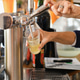 Bartender pouring fresh draft beer from tap into glass Bartender pouring fresh draft beer from tap into glass - PhotoDune Item for Sale