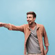 Emotional bearded man in grey cool t-shirt and stylish shirt showing aside is finger and rejoices o Emotional bearded man in grey cool t-shirt and stylish shirt showing aside is finger and rejoices o - PhotoDune Item for Sale