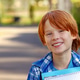 An open portrait of a smiling red-haired boy with with a notebook. An open portrait of a smiling red-haired boy with with a notebook. - PhotoDune Item for Sale