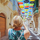 Woman from behind takes pictures of a street decorated with coloured umbrellas Woman from behind takes pictures of a street decorated with coloured umbrellas - PhotoDune Item for Sale