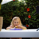 Happy smiling caucasian blonde girl playing with slime and watching cartoons on gadget Happy smiling caucasian blonde girl playing with slime and watching cartoons on gadget - PhotoDune Item for Sale
