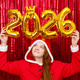 Cute girl in a santa costume holding golden balloons with the shape 2026 Cute girl in a santa costume holding golden balloons with the shape 2026 - PhotoDune Item for Sale