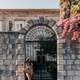 Attractive young woman wearing stylish summer clothes standing in front of stone wall house entrance Attractive young woman wearing stylish summer clothes standing in front of stone wall house entrance - PhotoDune Item for Sale