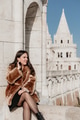 Portrait of stylish young woman sitting on walls of Fisherman's bastion in Budapest, Hungary Portrait of stylish young woman sitting on walls of Fisherman's bastion in Budapest, Hungary - PhotoDune Item for Sale