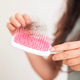 A girl holds dry, fallen hair with a comb after combing. The problem of hair loss and breakage A girl holds dry, fallen hair with a comb after combing. The problem of hair loss and breakage - PhotoDune Item for Sale