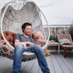 Happy smiling baby boy with his dad having fun on swing chair on summer terrace Happy smiling baby boy with his dad having fun on swing chair on summer terrace - PhotoDune Item for Sale