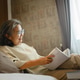 Elderly woman reading book appears calm and relaxed, enjoying a peaceful Elderly woman reading book appears calm and relaxed, enjoying a peaceful - PhotoDune Item for Sale