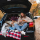 Happy mother with child girl having picnic in car trunk sitting on checkered blanket in woods Happy mother with child girl having picnic in car trunk sitting on checkered blanket in woods - PhotoDune Item for Sale