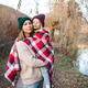 Mother holding kid girl 3-4 year old wrapped in red blanket wearing knitted hat over nature Mother holding kid girl 3-4 year old wrapped in red blanket wearing knitted hat over nature - PhotoDune Item for Sale